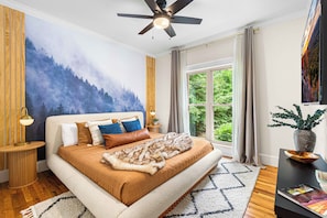 Unwind in the King bedroom on the main floor, featuring a mural of a forest.
