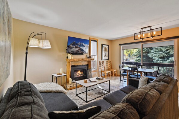 Cozy living room with gas fireplace + 55" screen w/surround sound soundbar.