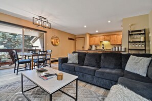Dining room table + balcony with mountain view + Sonos speaker.