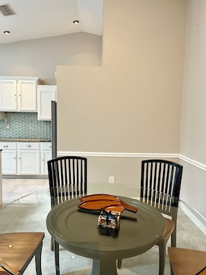Open floor-plan dining room by kitchen