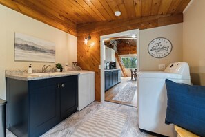 The laundry room is conveniently located just through the mudroom door