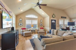 Relax in the welcoming Living Area with high ceilings, lush furniture, and a large Flat-Screen TV.