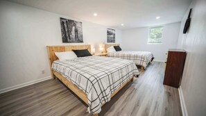 Bedroom 1: Comfort meets convenience in our room with two cozy beds, offering a relaxing retreat for all your guests!