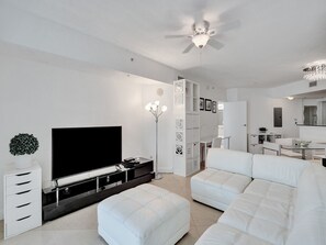 Relax in the spacious living room, complete with a large TV for entertainment.