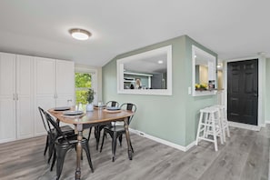 Dining room with 4 spots, and ample storage with floor to ceiling storage shelves.