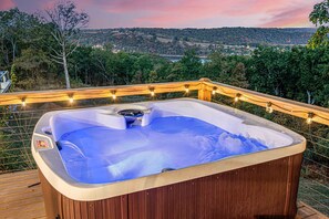 Unwind in our luxurious hot tub with stunning views overlooking the tranquil lake. Whether you're soaking in the warmth under a starry night or enjoying a peaceful morning, the serene lake bac