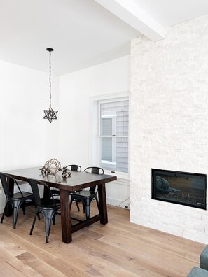 Dining area with nook and floor to ceiling stone fireplace.