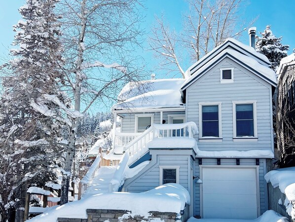 The house sits at the top of the hill on Woodside Ave