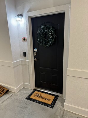 Front door with nest camera and digital
Lock.
