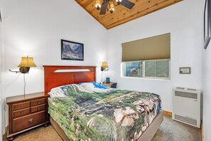 The private bedroom offers soaring ceilings & a regal queen-sized bed