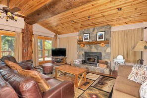 Cozy and spacious living area with TV and fireplace