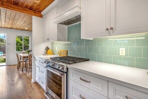 The gleaming coastal kitchen is spacious & offers all the comforts of home