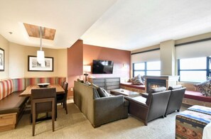 Spacious living and dining area with modern furnishings and large windows.