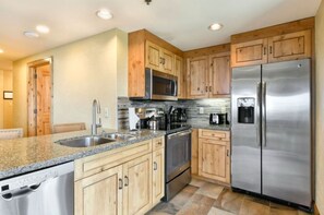 Modern kitchen with stainless steel appliances and ample counter space.