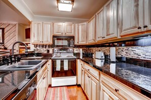 Modern kitchen with high-end appliances and ample counter space.