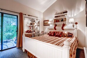 Charming bedroom with a rustic vibe and private balcony access.