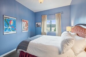 A tranquil, sunlit queen room with a calming atmosphere.