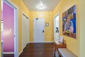 Step into comfort and color—our suite welcomes you with a bright, cheerful entryway adorned with vibrant local art.