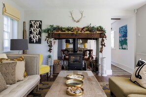 Stylish living room with a view of the rustic fireplace, creating a warm and inviting atmosphere