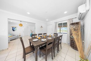 Enjoy comfort year-round in this inviting dining area, complete with AC! Perfect for warm evenings, it’s the ideal space for meals and memories with family and friends.
