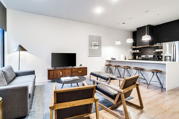 Living, dining & kitchen spaces blend seamlessly in this open-concept area.