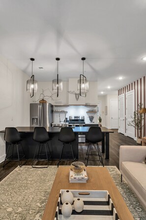 Fully equipped kitchen with barstool seating.