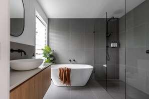 A spacious king ensuite with a bathtub for ultimate relaxation.