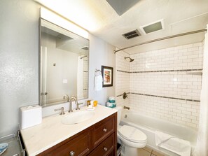 Full bathroom with tub and shower combo.
