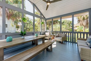 Feel the ocean breeze from the screened-in outdoor porch with plenty of seating