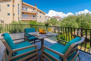 Spacious balcony overlooking garden and quiet neighborhood. 