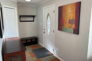 Roomy entrance area with corner closet and shoe/coat storage