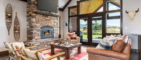 The well-appointed and well-lit living space has easy access to the backyard. Unique western decor can be found throughout the home.