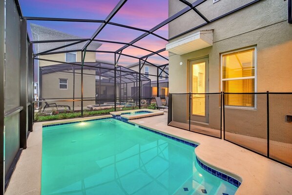 Relax and unwind in your private pool oasis, beautifully illuminated at sunset.