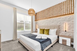 Sleep comfortably in our stylish bedroom featuring chic decor and plush bedding.