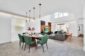 Enjoy the spacious open-concept living and dining area, perfect for family gatherings and entertaining. Features modern decor and plenty of natural light.