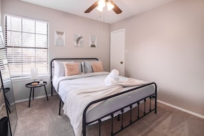 Relax in this serene bedroom, designed for comfort and tranquility. Enjoy the blackout curtains for undisturbed sleep, soft textiles for extra coziness, and a clutter-free space that promotes peace and rejuvenation for a restful stay.