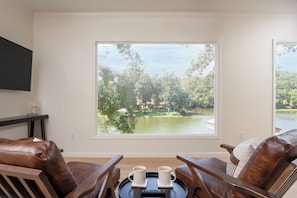 Bedroom with personal living room, bathroom, and view of the lake