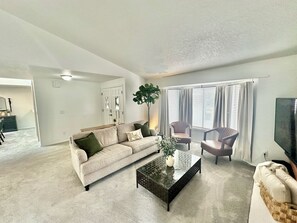 Cozy living room with a fireplace and 60” smart TV. 