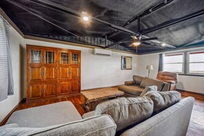 This living room features a large, comfortable seating area and a Smart TV for entertainment. It’s the perfect spot to relax after a day in the sun or to enjoy some downtime with your group.
