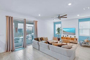 Bright, airy living room with cozy seating and a seamless outdoor view.