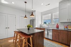 kitchen on second floor stainless appliances, gas stove