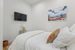 Bedroom 1 on main floor queen bed, cozy earth sheets