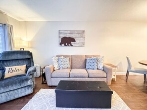 Cozy sofa bed setup with charming bear decor and plush seating—perfect for relaxation and comfort