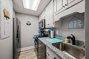 The kitchen has been completely updated with new countertops, stainless steel appliances, kitchen utensils and more.