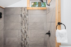 Luxury Shower Retreat: Elegant tile design and a rain shower create your perfect spa experience!