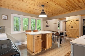 Our well-equipped eat-in kitchen is perfect for family meals, with seating for six at the counter-height table and two at the kitchen island—ideal for gathering and enjoying time together.