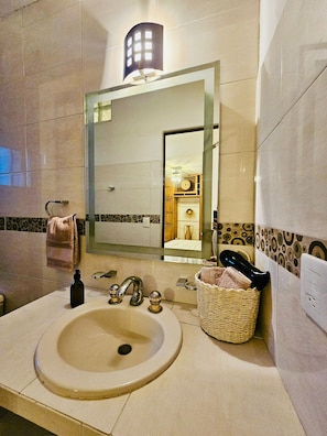 A fully equipped bathroom features mood lighting to relax and enjoy.