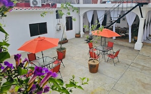 Our relaxing patio space with different plants, shaded areas and comfy seats.