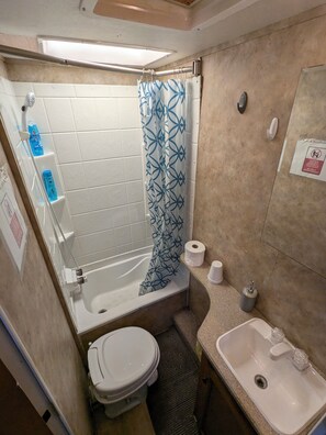 A cozy full bath with tub that may not convenient for big guys or elderlies. 
