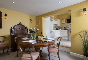 The traditional dining room has a table with seating for four guests